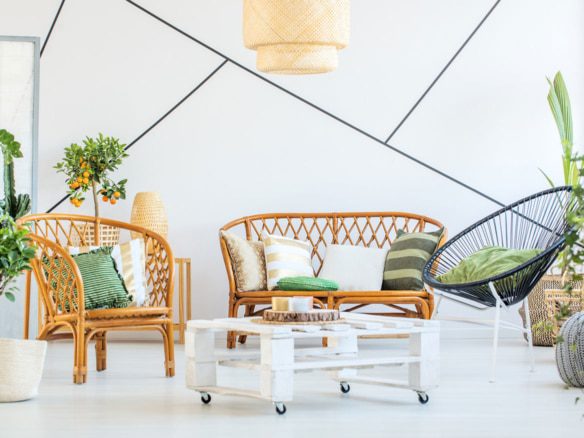 Bright living room with wicker furniture and green accents.