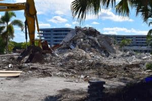 Construction site with rubble and building debris under a clear sky.