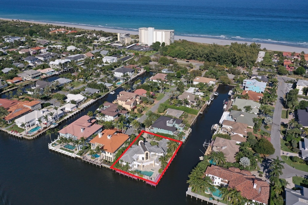A waterfront property with a boat dock and nearby ocean view.